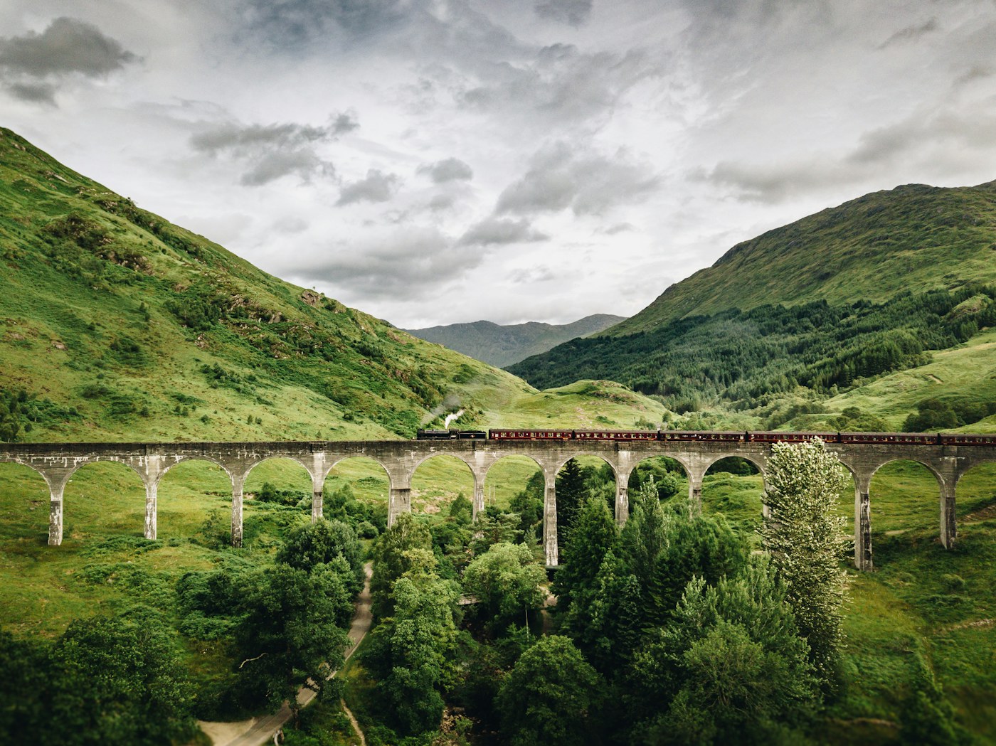 Train travelling across Glenfinnan Viaduct